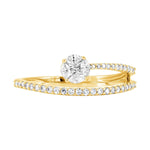 A yellow gold engagement ring with a round-cut diamond center stone and a matching diamond pavé band, shown on a plain white background.